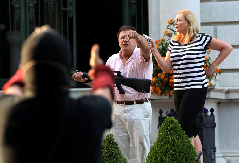 Armed homeowners Mark T. and Patricia N. McCloskey stand in front their house as they confront protesters marching to St. Louis Mayor Lyda Krewson's house on June 28, 2020. The protesters called for Krewson's resignation for releasing the names and addresses of residents who suggested defunding the police department. (Laurie Skrivan/St. Louis Post-Dispatch/TNS) Armed homeowners Mark T. and Patricia N. McCloskey stand in front their house as they confront protesters marching to St. Louis Mayor Lyda Krewson's house on June 28, 2020. The protesters called for Krewson's resignation for releasing the names and addresses of residents who suggested defunding the police department. (Laurie Skrivan/St. Louis Post-Dispatch/TNS)