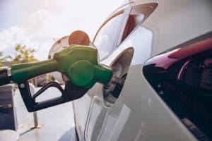 green gasoline pump in car