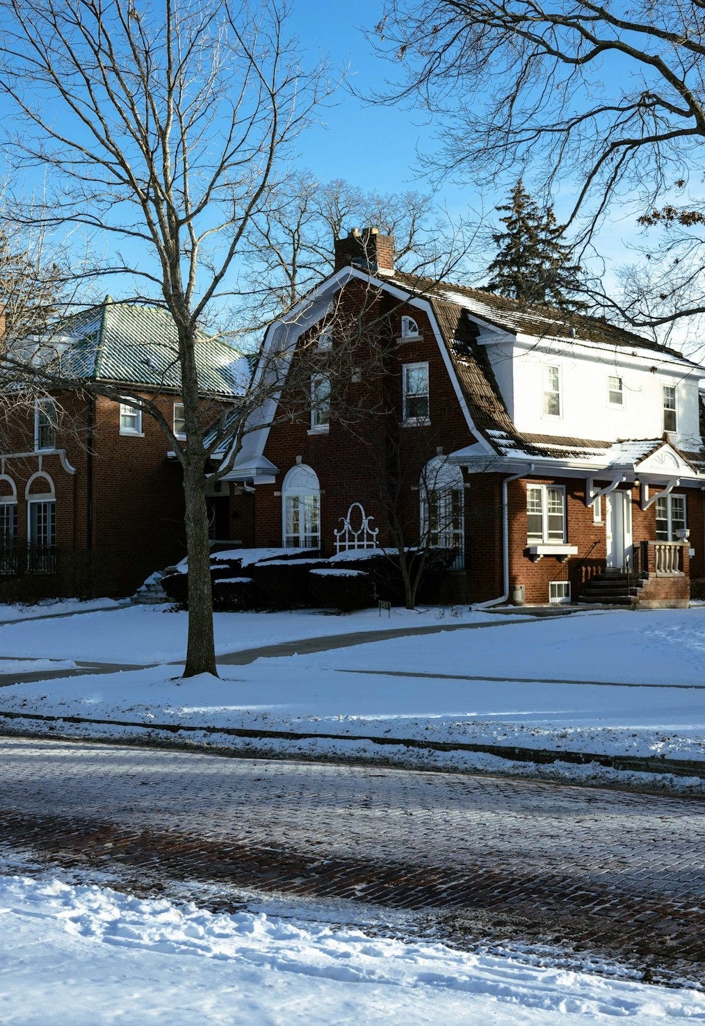 a red brick house with snow on the ground a red brick house with snow on the ground