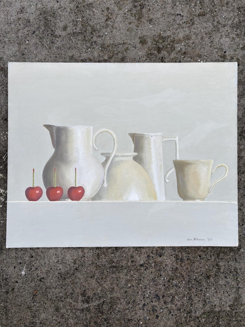 May include: Still life painting featuring white ceramic pitchers, a bowl, and a teacup. Three bright red cherries with stems are in the foreground. The artwork is signed "Ben Altman '85".