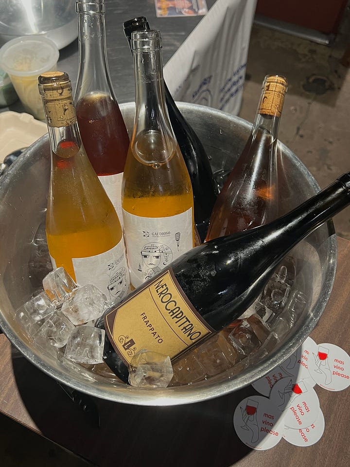 first image is an ice bucket full of wine bottles, second image is a group of people sitting outside a cafe at night drinking wine on the sidewalk.