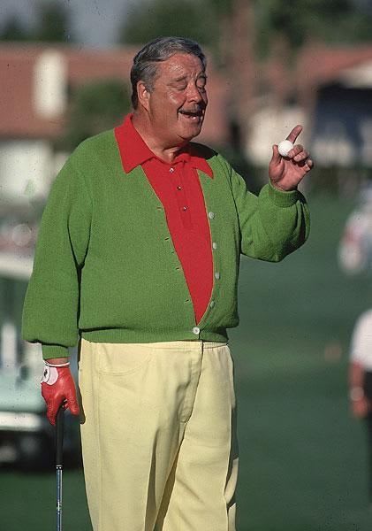 This may contain: an older man holding a golf ball in his right hand