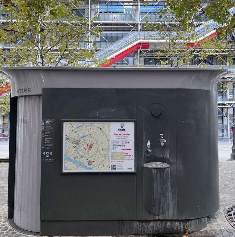 A small black and grey building with a map on the side

AI-generated content may be incorrect.