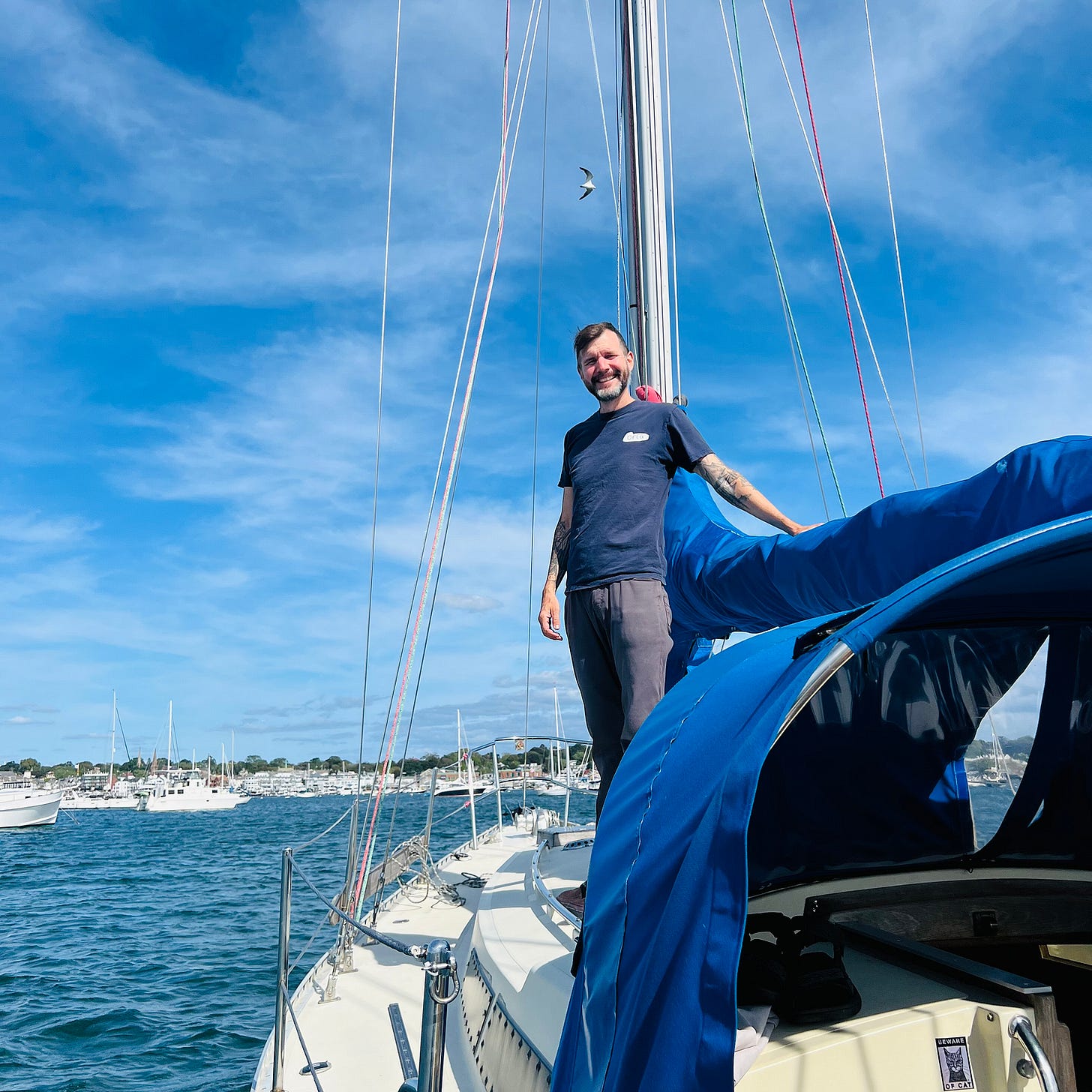 Captain standing on sailboat in Newport