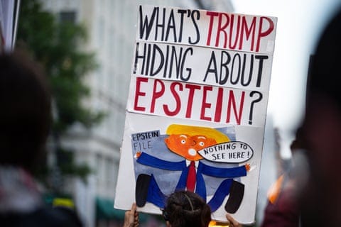 A demonstrator holds a sign saying 'What's Trump hiding about Epstein?'