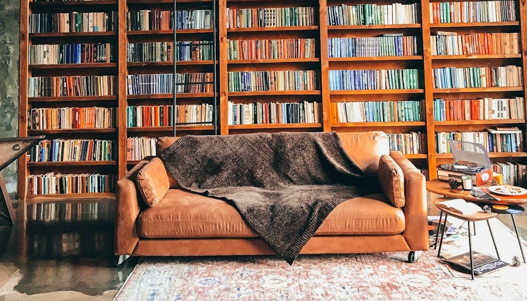 brown wooden book shelves with books brown wooden book shelves with books