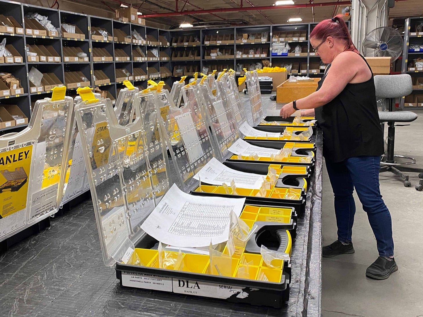 F-35 warehouse specialist preparing component kits inside a Defense Logistics Agency facility.
