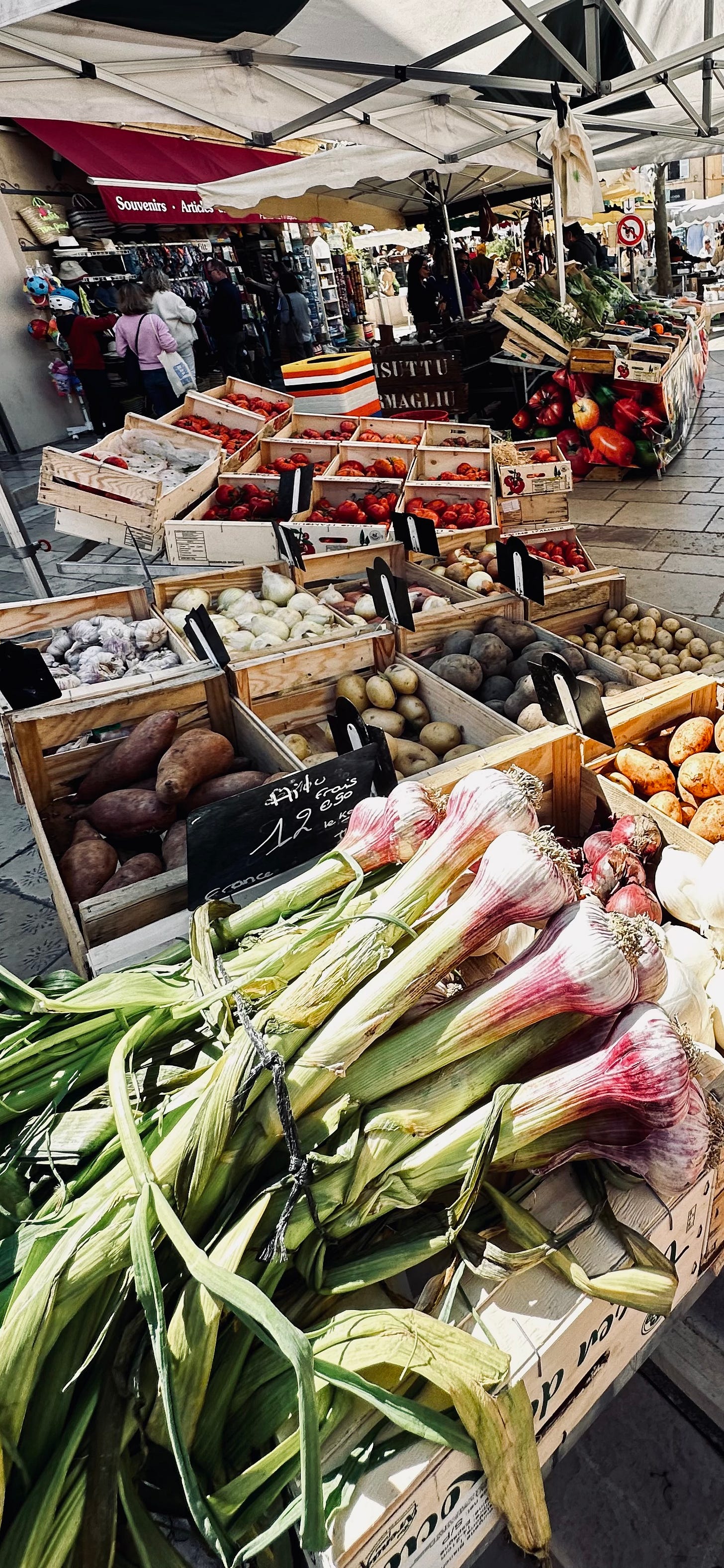 Outdoor market stall in Cassis with fresh vegetables and local produce, photographed during everyday shopping while slow traveling.
