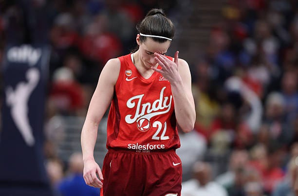 Caitlin Clark of the Indiana Fever reacts after missing a shot in the second half against the Las Vegas Aces at Gainbridge Fieldhouse on August 06,...