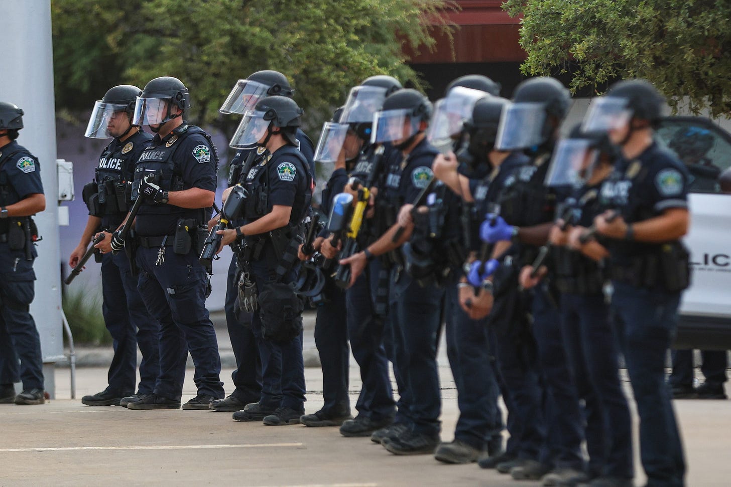 Austin police hold pepper ball guns as protesters confront officers at the scene of Sunday’s shooting. (Photo by Jacob Lujan/The Texas Tribune) Austin police hold pepper ball guns as protesters confront officers at the scene of Sunday’s shooting. (Photo by Jacob Lujan/The Texas Tribune)