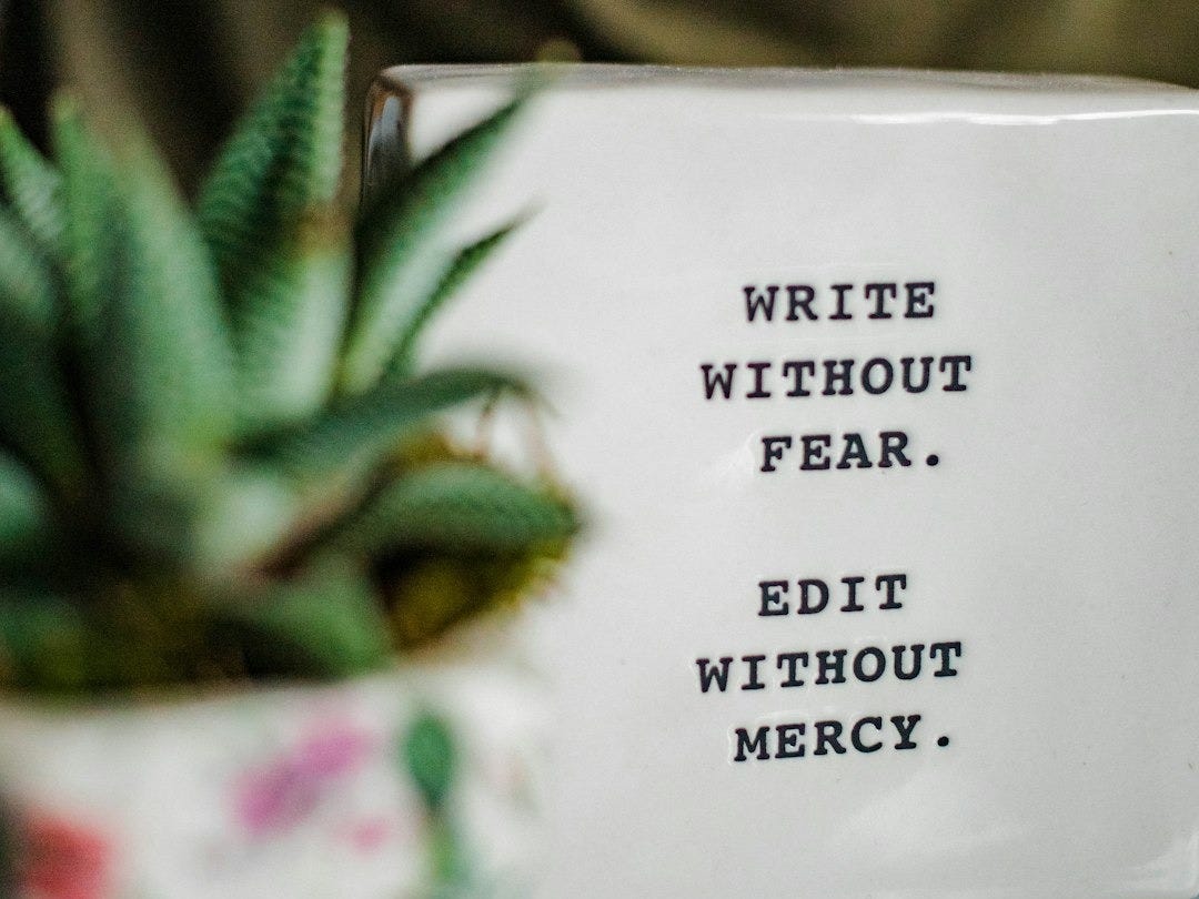 a white box with writing on it next to a plant