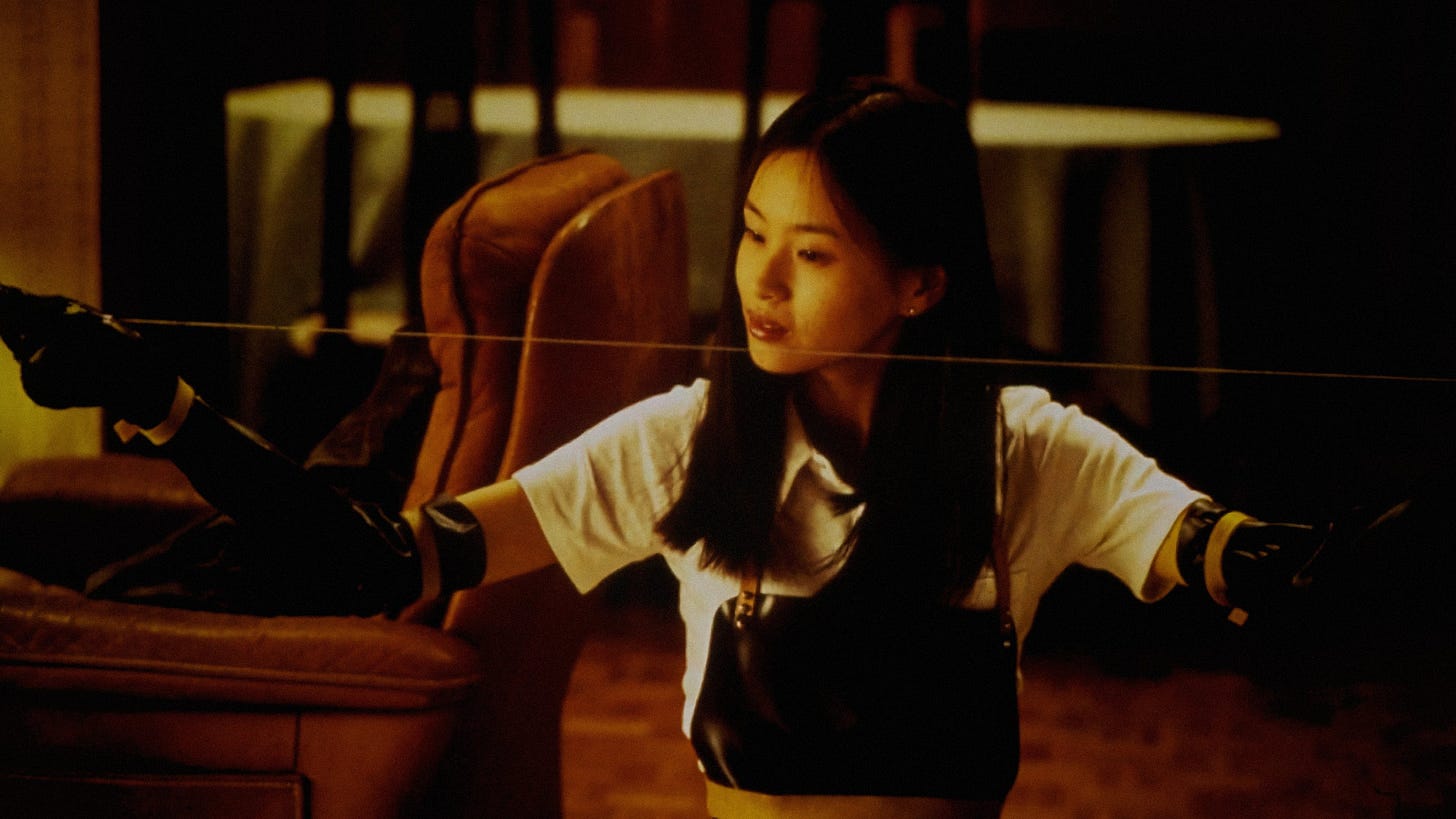 Audition | Still featuers Eihi Shiina as Asami Yamazaki holding a wire saw.