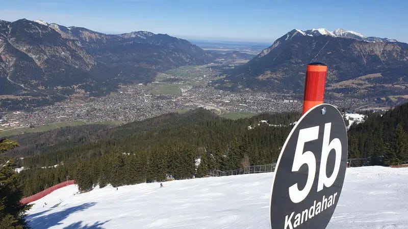 A picture containing text, mountain, snow, outdoor

Description automatically generated