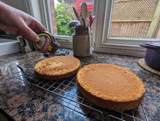 A person pouring a jar onto a cake

AI-generated content may be incorrect.