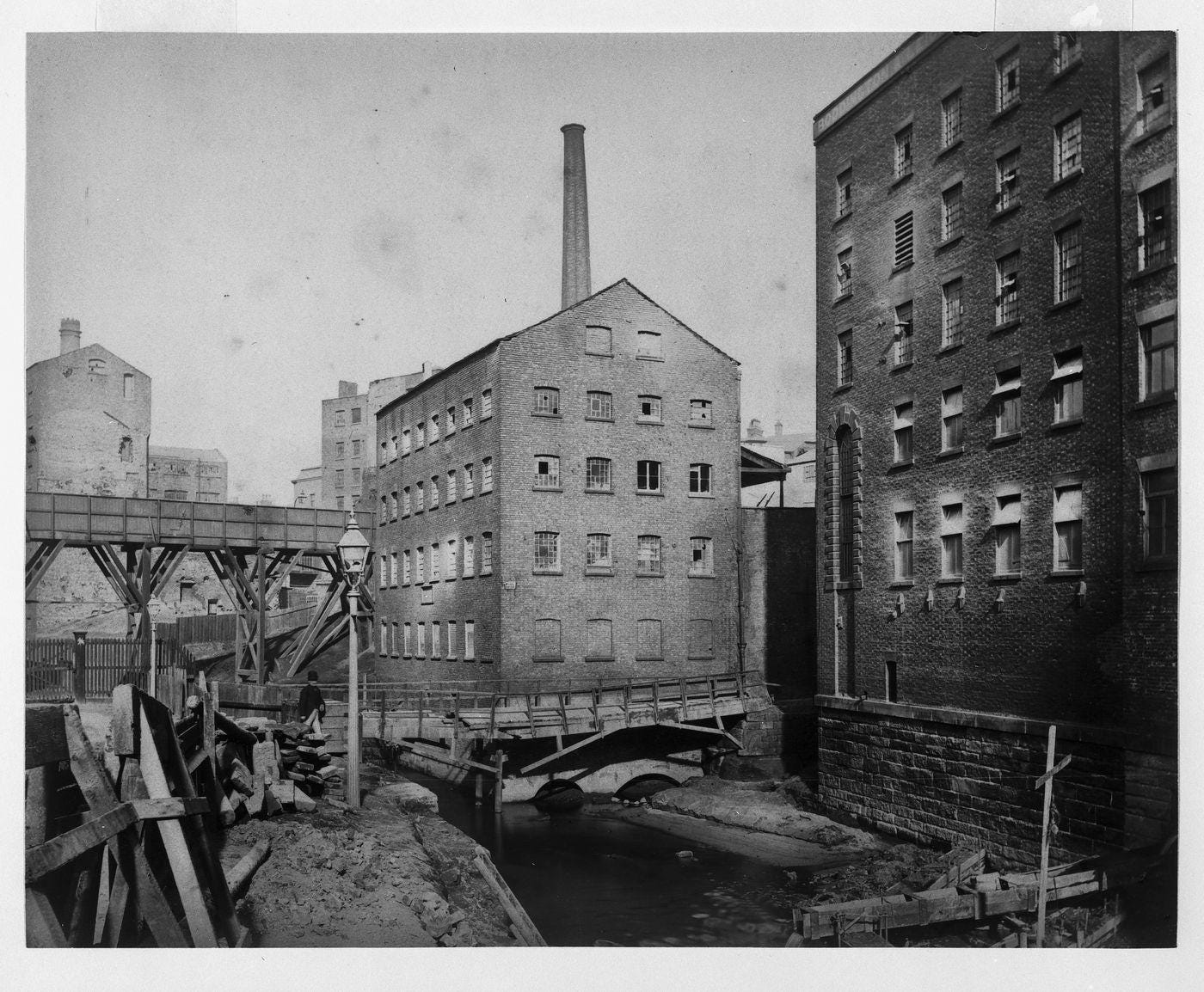 View of footbridge over the river Irk and School Mills, Manchester, England View of footbridge over the river Irk and School Mills, Manchester, England