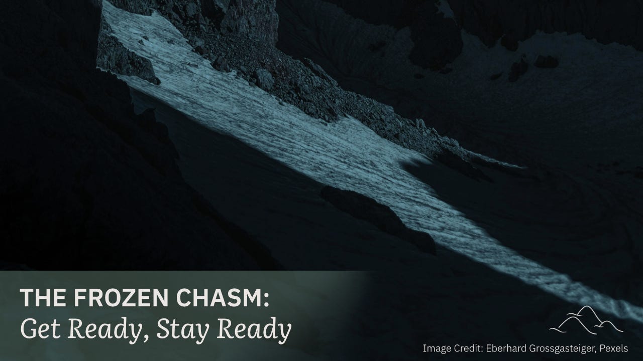 Image Description: A dark image of a snow-capped mountainous chasm at night time. At the lower left, “The Frozen Chasm: Get Ready, Stay Ready” is written in light gray on top of a transparent olive green background. Image Description: A dark image of a snow-capped mountainous chasm at night time. At the lower left, “The Frozen Chasm: Get Ready, Stay Ready” is written in light gray on top of a transparent olive green background.