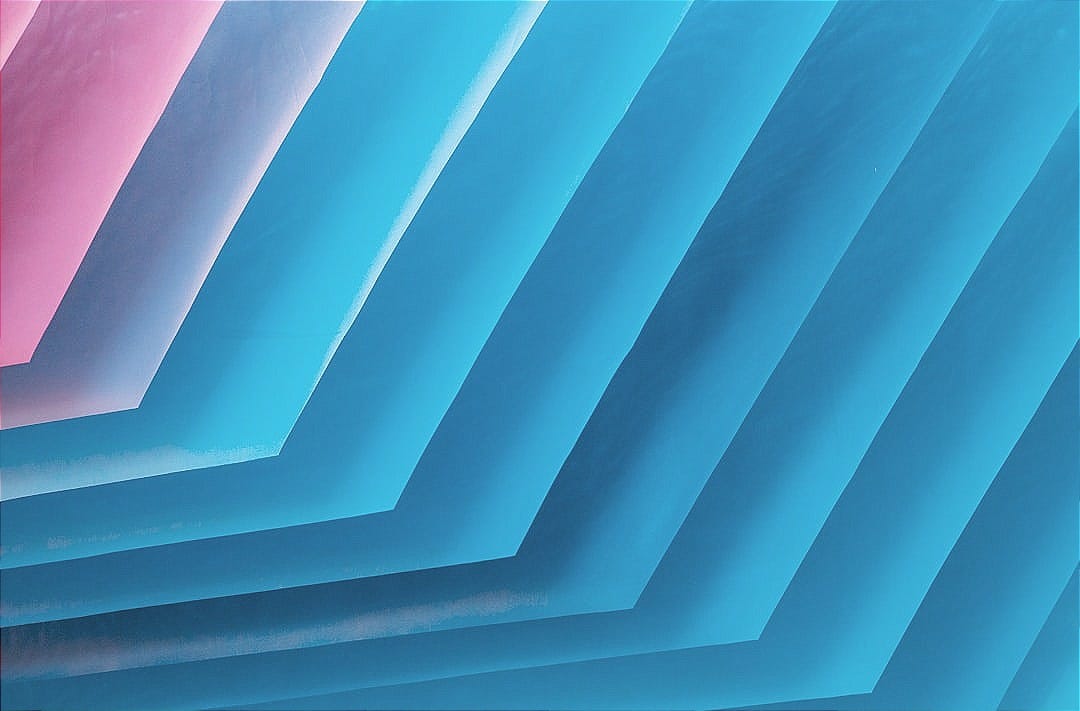 a bunch of blue and pink papers stacked on top of each other
