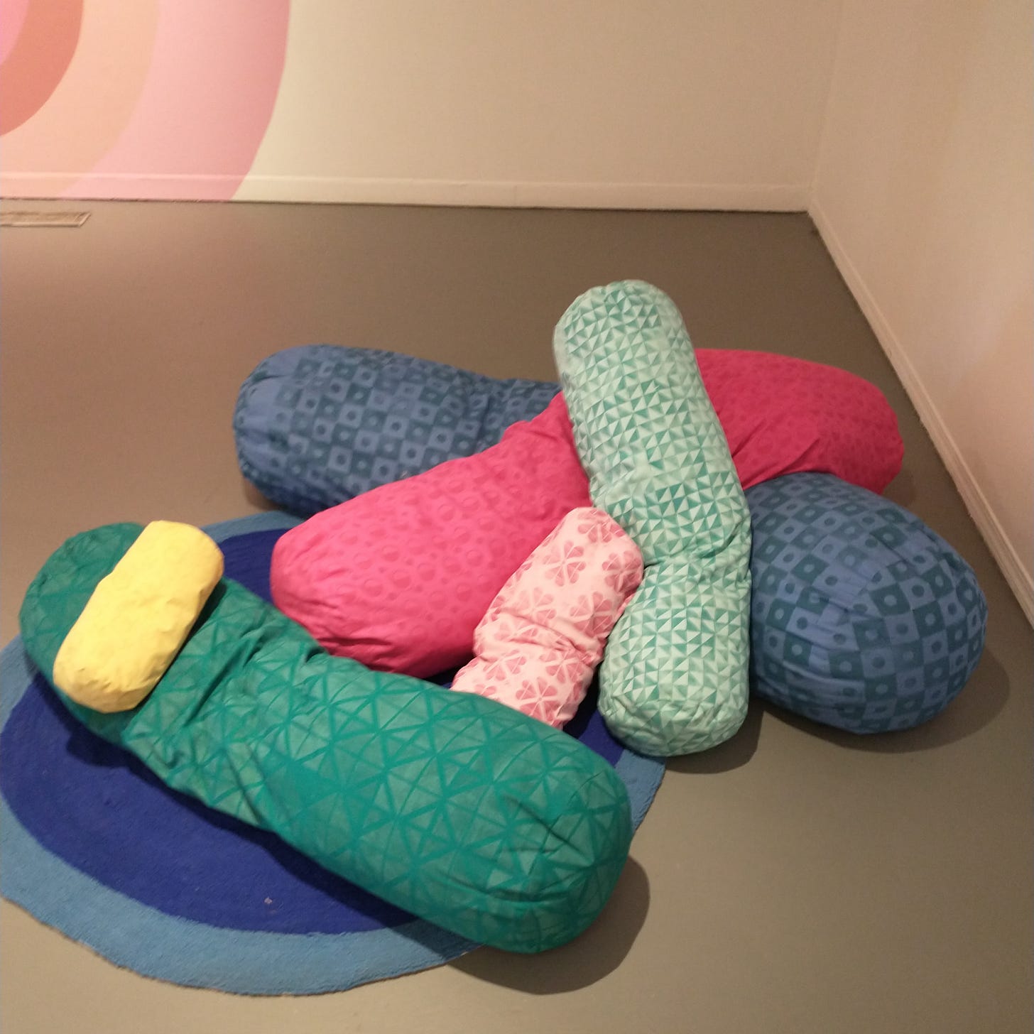 6 tube-shaped pillows with various block-printed pattern fabric, various sizes.
