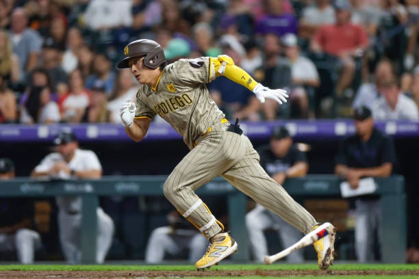 Ha-Seong Kim of the San Diego Padres starts to run to first base in the sixth inning during a game against the Colorado Rockies at Coors Field on...
