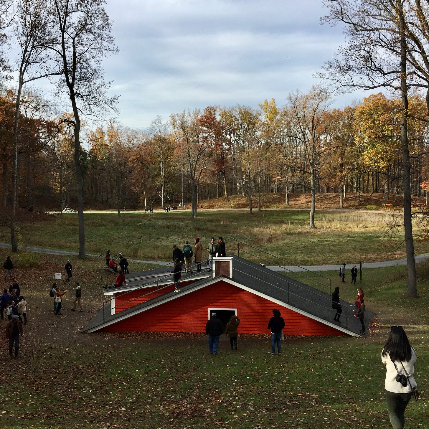 The roof of a red house peeks out of the ground