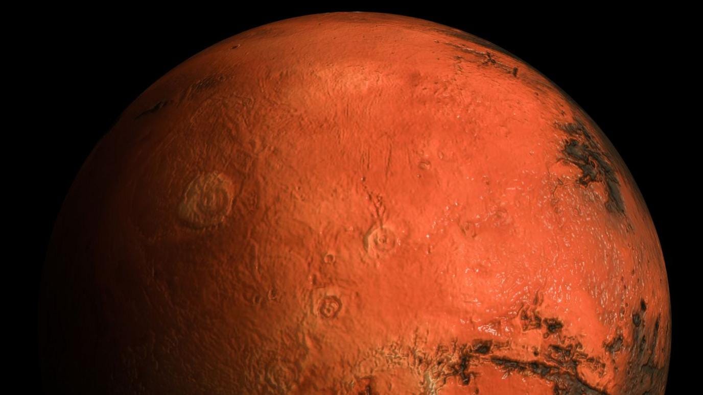 The photograph is a high-resolution 3D close-up view of the planet Mars showing its rugged surface, reddish terrain, and detailed geological features The photograph is a high-resolution 3D close-up view of the planet Mars showing its rugged surface, reddish terrain, and detailed geological features