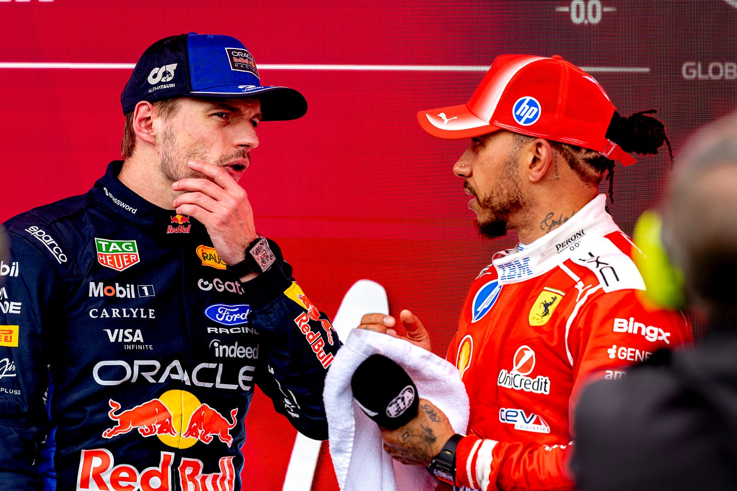 Max Verstappen and Lewis Hamilton in conversation in the pit lane after a race