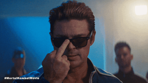 a man wearing sunglasses is giving the middle finger in a #mortalkombat movie a man wearing sunglasses is giving the middle finger in a #mortalkombat movie