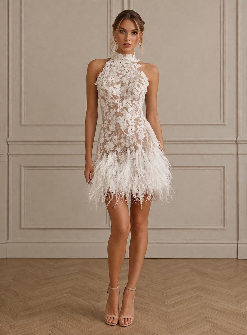 May include: A white lace mini dress with a high neckline and a feathered skirt. The dress features floral lace detailing and a halter-style top. The model is wearing nude-colored heels. The dress is suitable for special occasions.