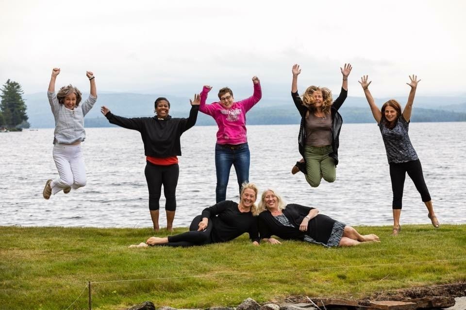 A group of people jumping in the air

Description automatically generated
