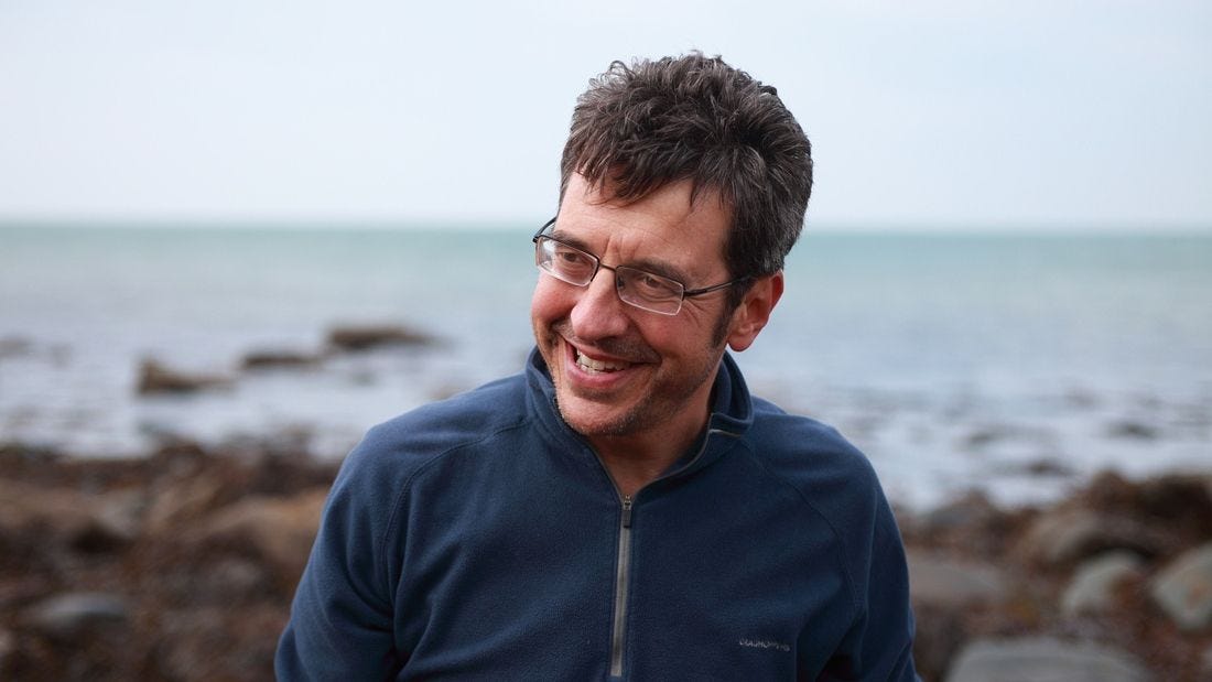 A person smiling at the camera

Description automatically generated