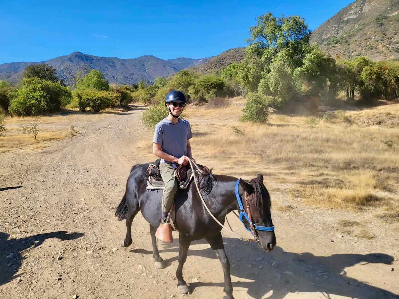 Jeff on the back of a dark-brown mare Jeff on the back of a dark-brown mare