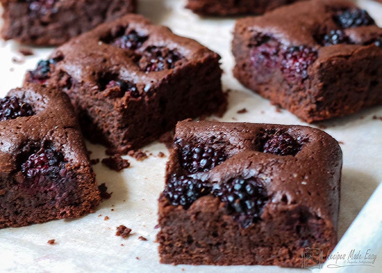 blackberry brownies on baking parchment.