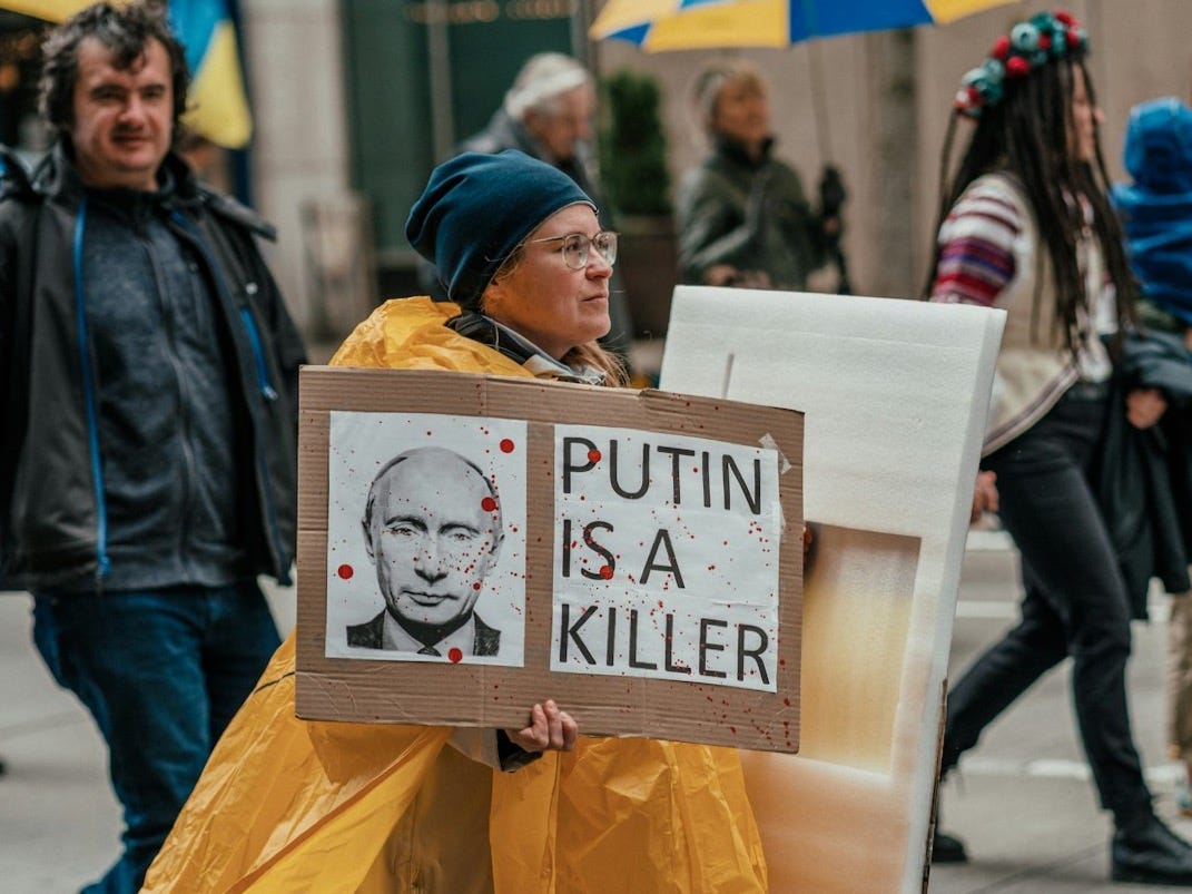 a person walking down a street holding a sign a person walking down a street holding a sign