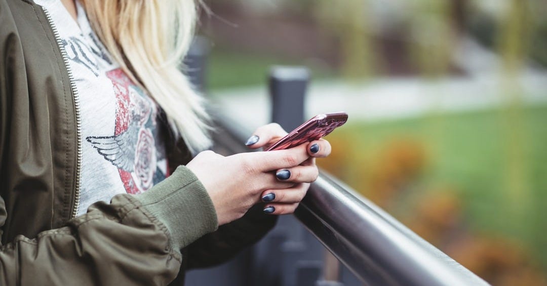 woman holding red phone