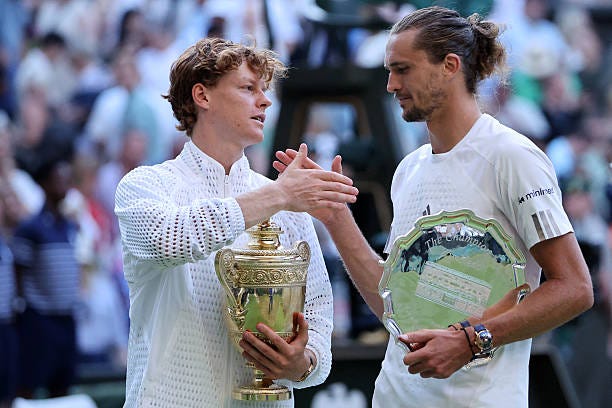 Italy's Jannik Sinner holds the Gentlemen's Singles Trophy after winning the men's singles final tennis match against Germany's Alexander Zverev on...