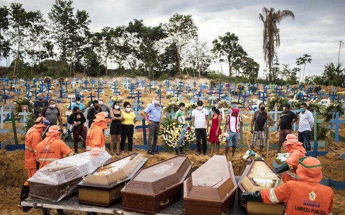 People attend a funeral at a mass grave at the Nossa Senhora Aparecida cemetery in Manaus, Brazil, 23 April 2020. The new section of the cemetery was opened amid a sharp rise in Covid-19 victims People attend a funeral at a mass grave at the Nossa Senhora Aparecida cemetery in Manaus, Brazil, 23 April 2020. The new section of the cemetery was opened amid a sharp rise in Covid-19 victims