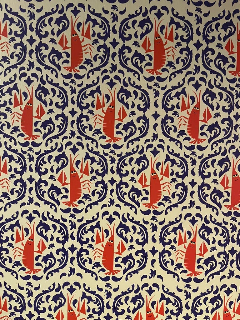 A hexagonal-tile wallpaper pattern with red cartoon crawfish surrounded by blue wave-like squiggles