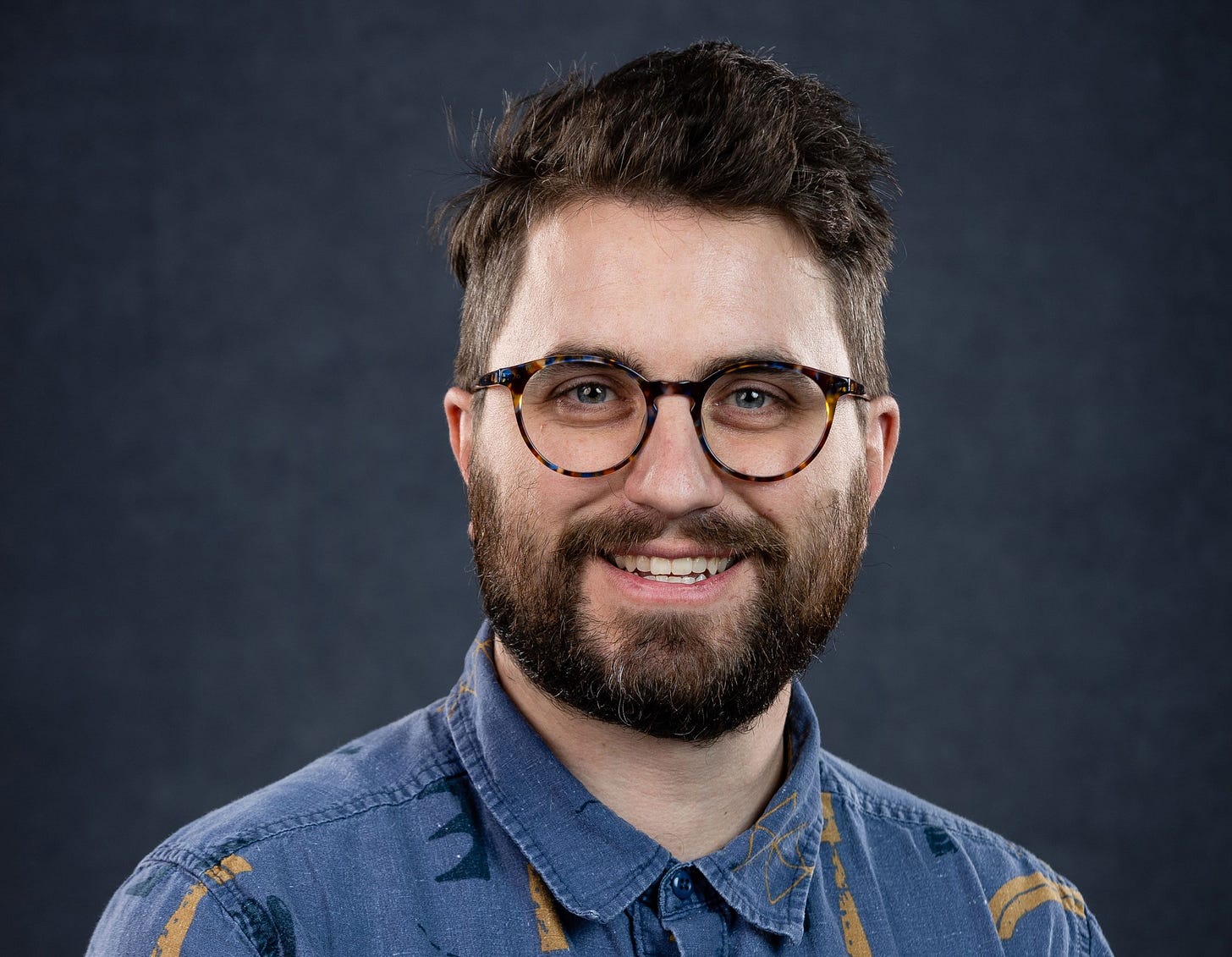 man in glasses and blue collared shirt