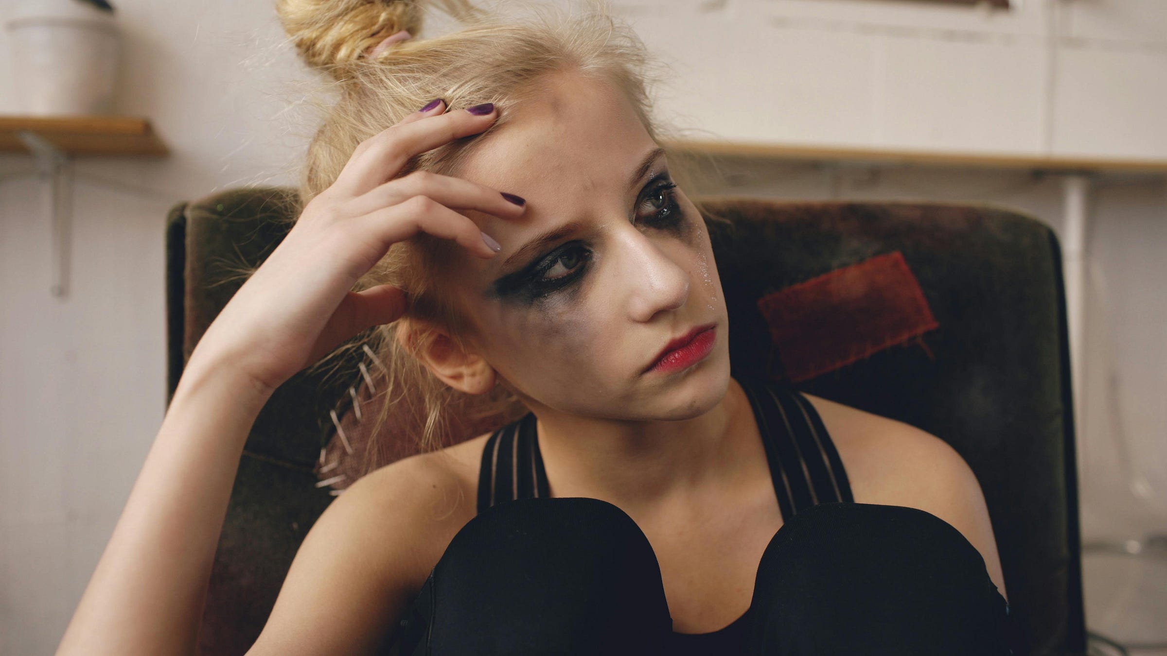 A teen girl with smudged makeup looking upset A teen girl with smudged makeup looking upset
