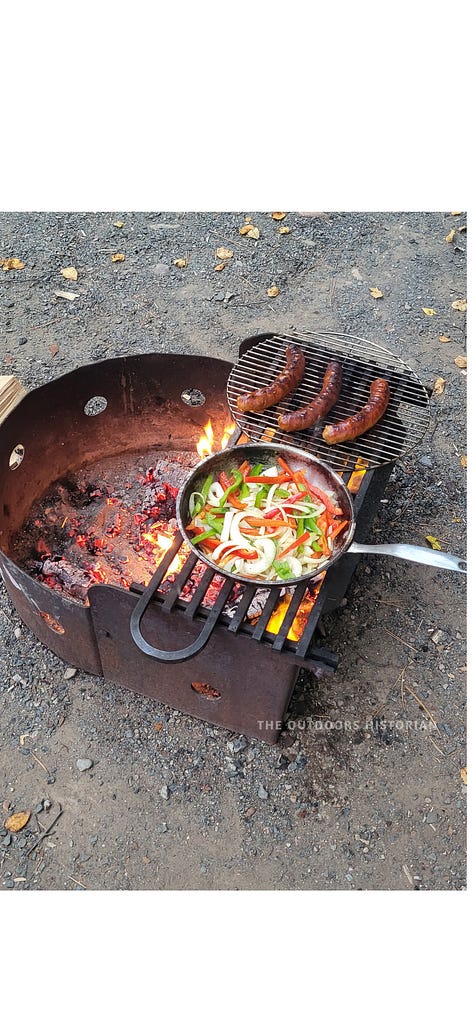 A three-photo sequence: sausages and peppers cooking over an open fire, a lidded pot simmering on a Whisperlite camp stove, and a box of fresh pastries from the iconic Silver Islet General Store.