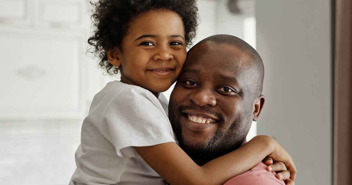 father and son smiling at the camera