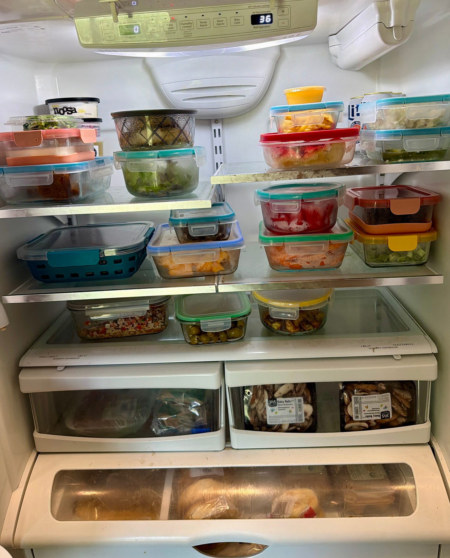 Youth strength coach's refrigerator in Westmont IL stocked with glass containers of prepped fruit, vegetables, cooked proteins, rice, and ready-to-eat real food for student athletes Youth strength coach's refrigerator in Westmont IL stocked with glass containers of prepped fruit, vegetables, cooked proteins, rice, and ready-to-eat real food for student athletes