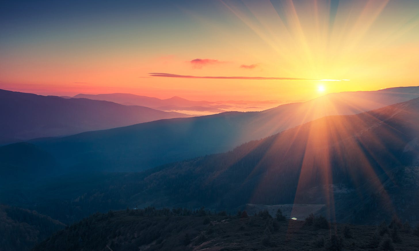 A rising sun over mountains