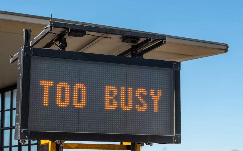 a sign with the words too busy written on it