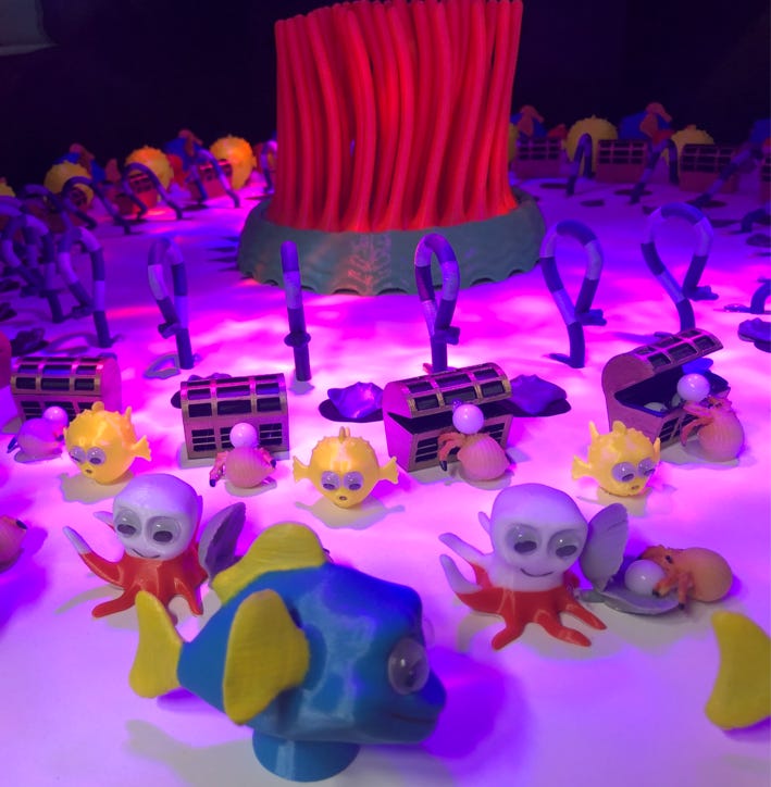 Colorful, playful scene featuring toy skeletons, fish, and treasure chests illuminated by purple lighting.
