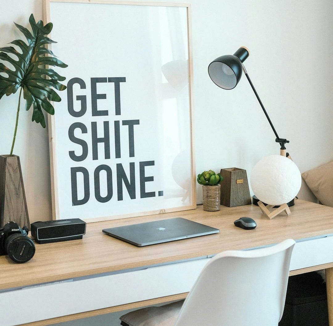 brown and white wooden desk with chair and laptop