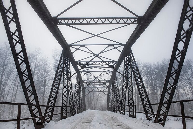 File:Fog rolls in just above the tree tops in a winter bridge.jpg