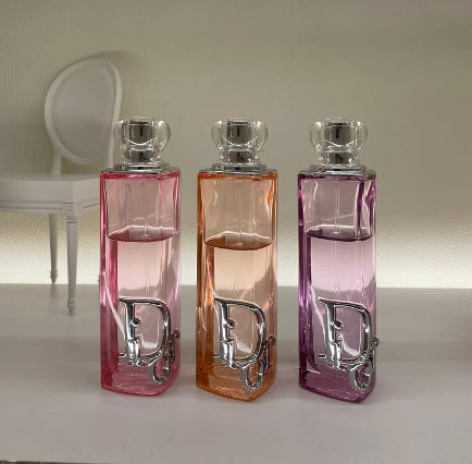 Dior Addict Glow Fragrance bottles in Rosy Glow, Purple Glow and Peachy Glow