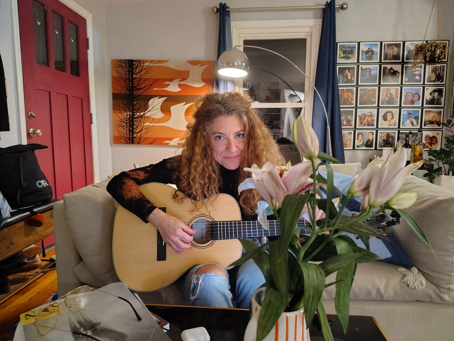 amie newman playing guitar on couch amie newman playing guitar on couch