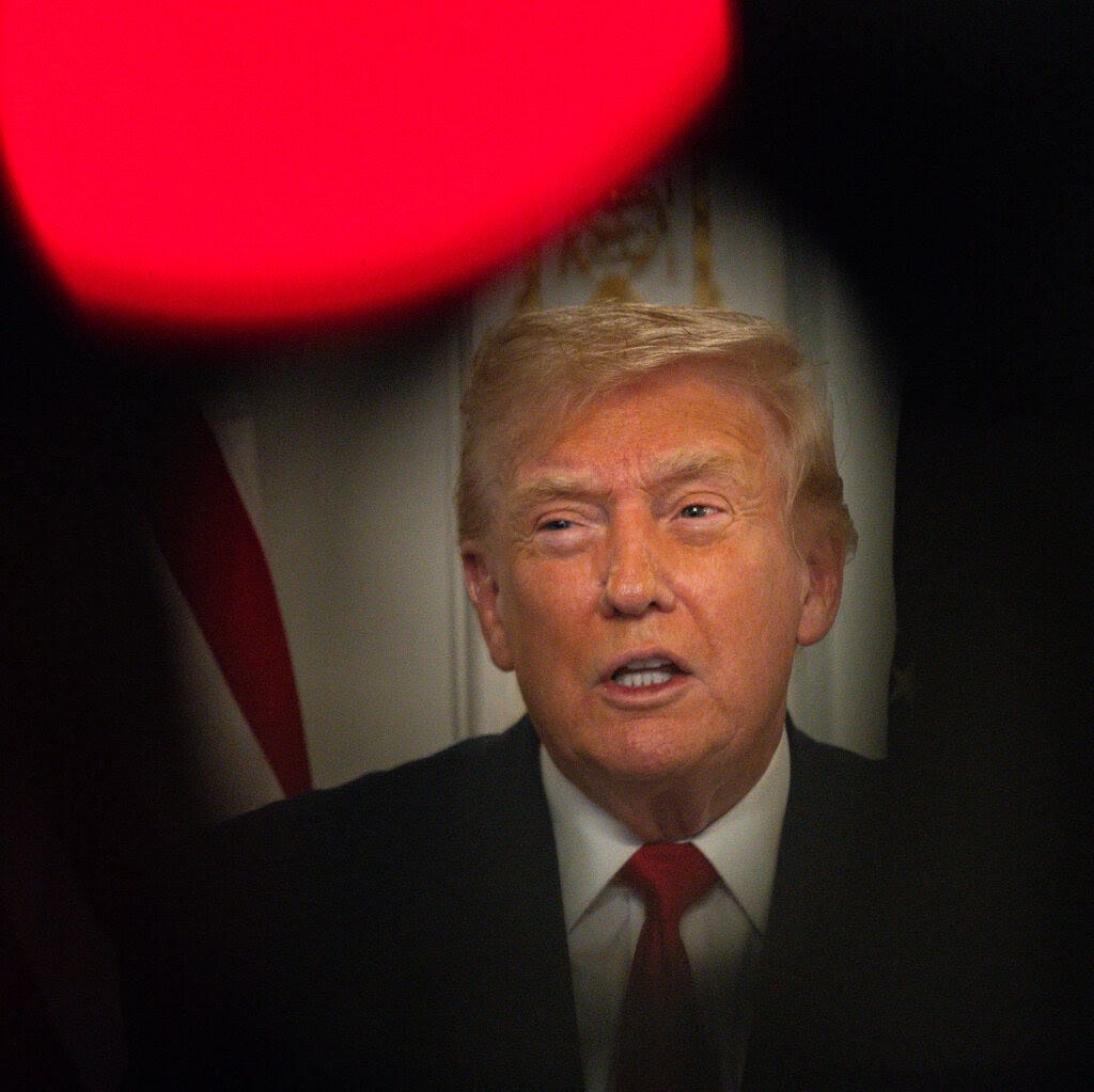 President Trump in a dark suit and red tie.